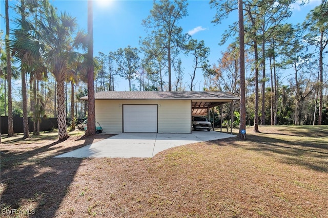 garage featuring a carport and a yard