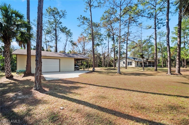 view of yard featuring a garage and a carport