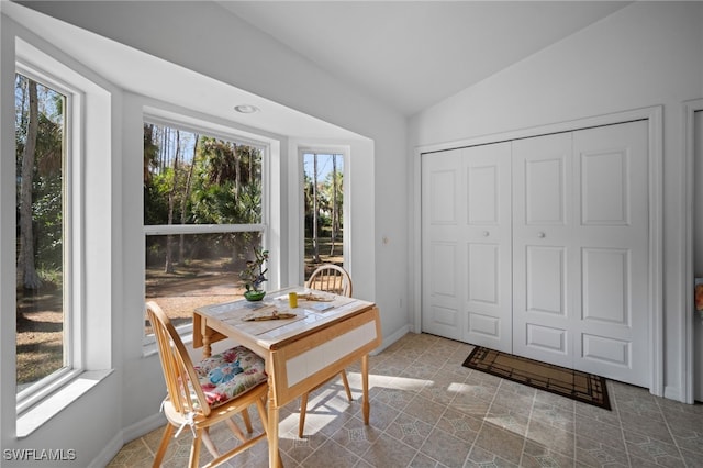 dining room with lofted ceiling