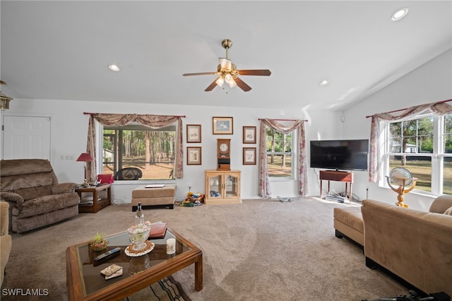 living room with ceiling fan, carpet flooring, and lofted ceiling