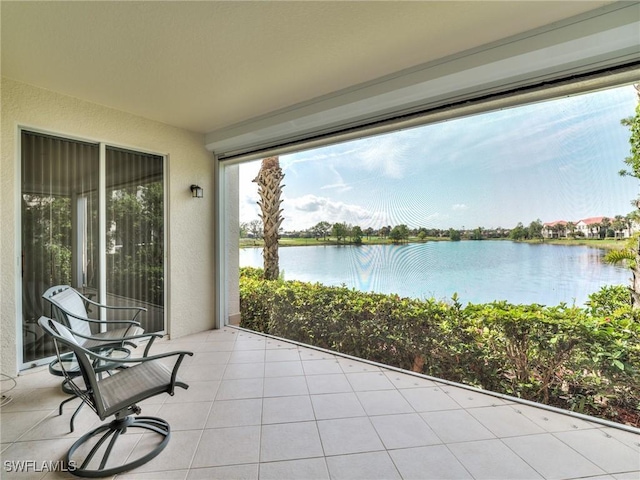 unfurnished sunroom featuring a water view