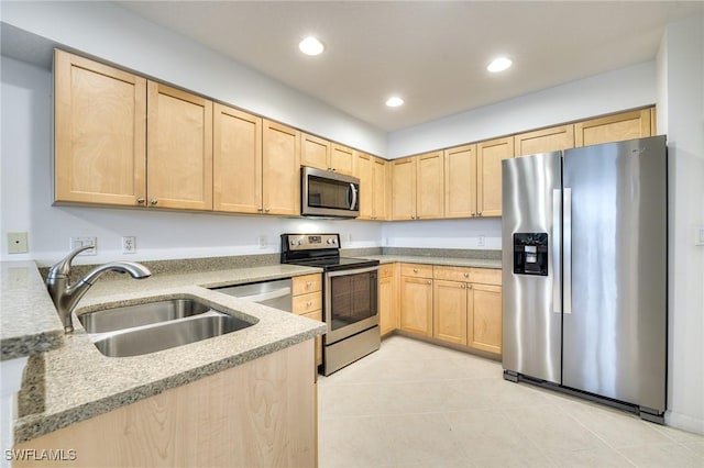 kitchen featuring light brown cabinetry, sink, light stone countertops, and appliances with stainless steel finishes