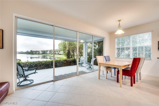 tiled dining space with a water view