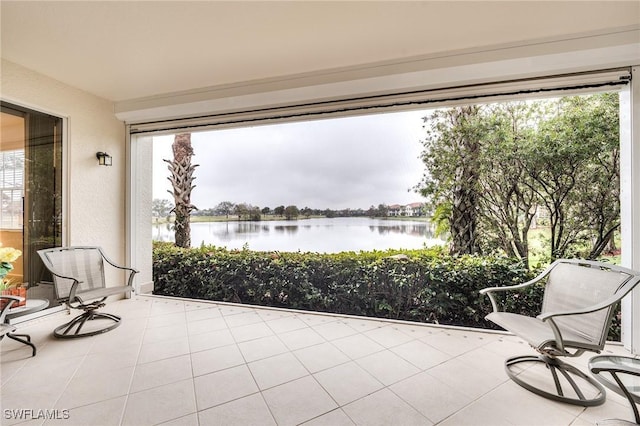 unfurnished sunroom with a water view