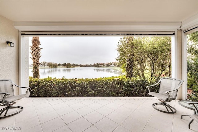 unfurnished sunroom featuring a water view