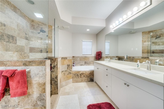 bathroom featuring vanity and separate shower and tub