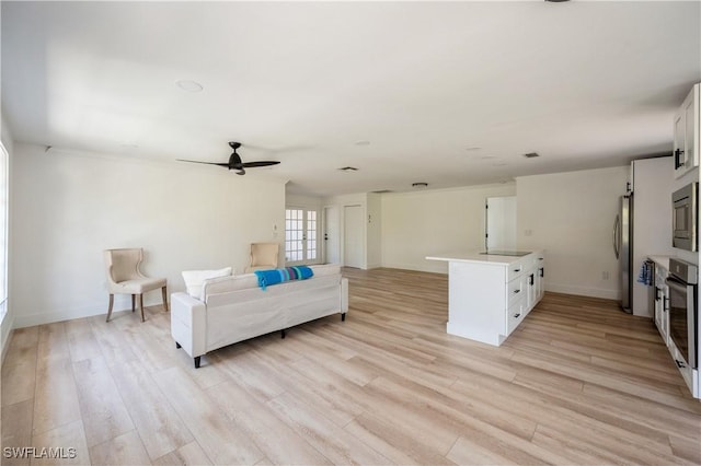 living room with ceiling fan and light wood-type flooring