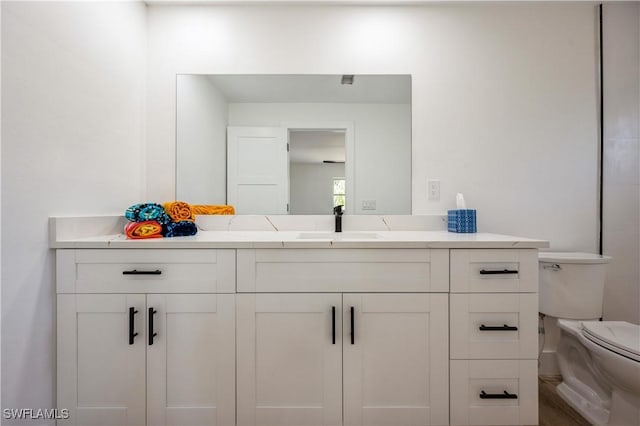 bathroom featuring vanity and toilet