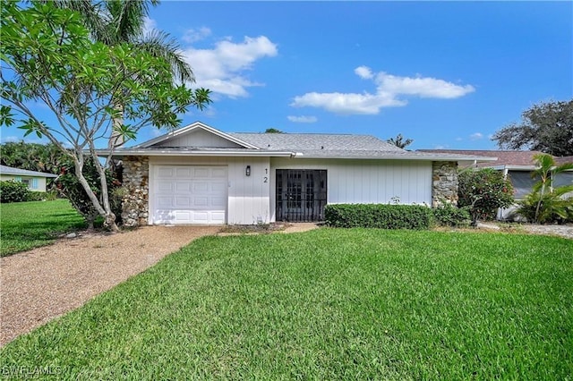 single story home featuring a front lawn and a garage