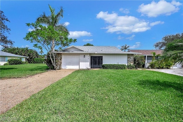 single story home featuring a front yard and a garage