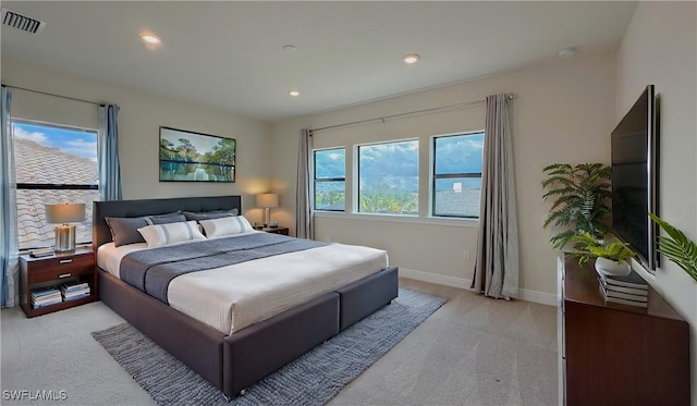 carpeted bedroom with multiple windows