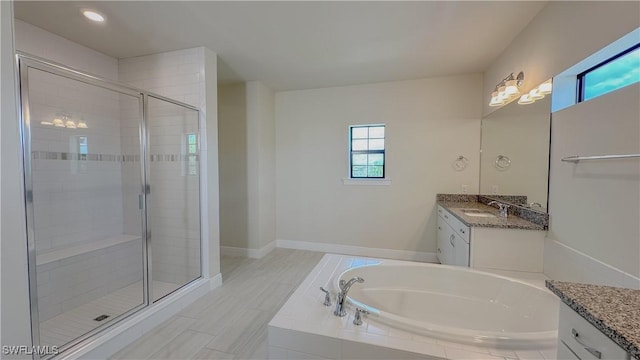 bathroom with vanity and separate shower and tub