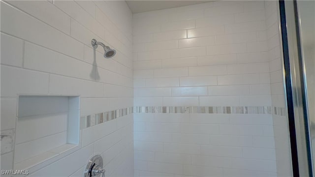 interior details with a tile shower