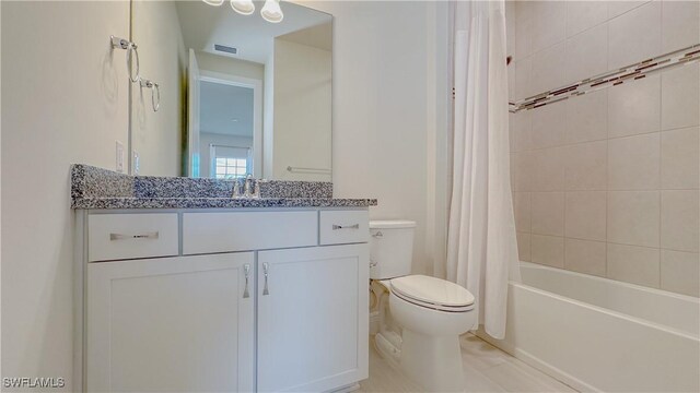 full bathroom with toilet, vanity, and shower / bath combo