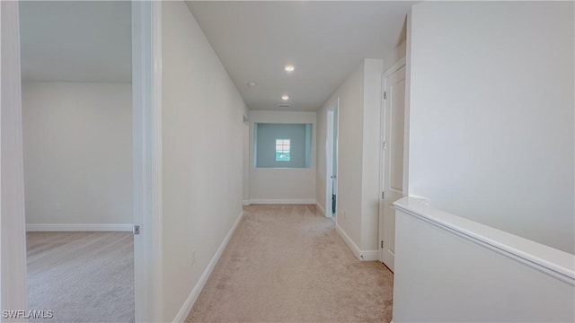 hallway featuring light carpet