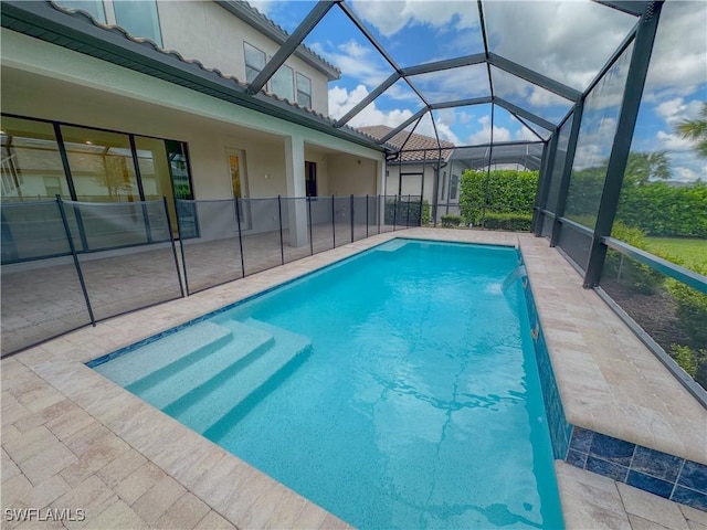 view of pool featuring a patio area, a lanai, and pool water feature