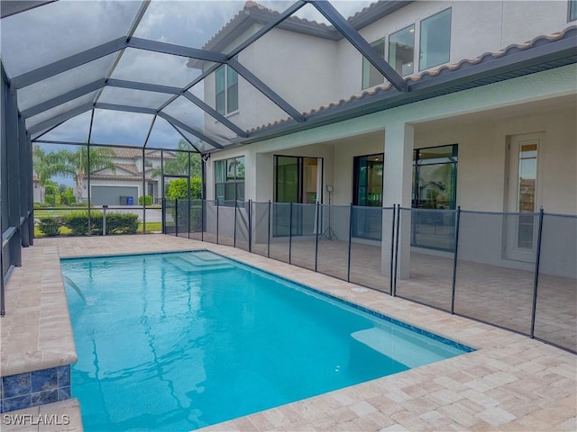 view of swimming pool featuring a lanai and a patio area