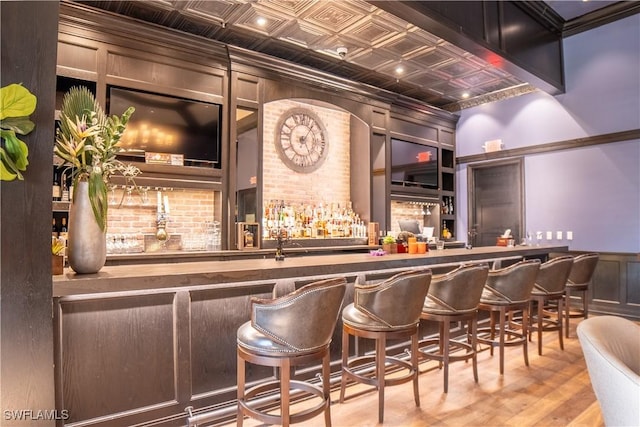 bar with hardwood / wood-style floors