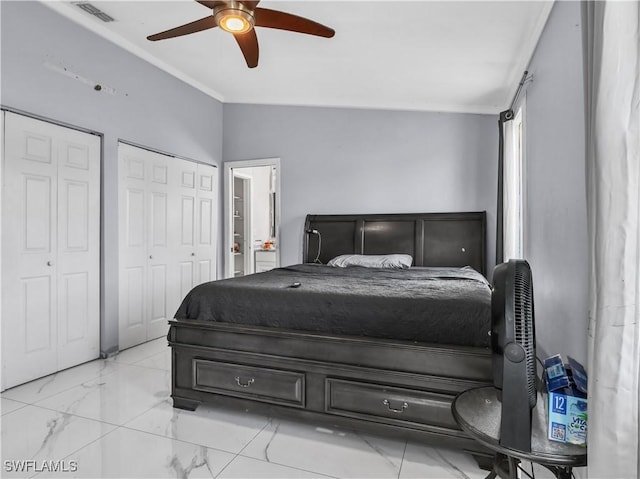 bedroom featuring crown molding, vaulted ceiling, two closets, and ceiling fan