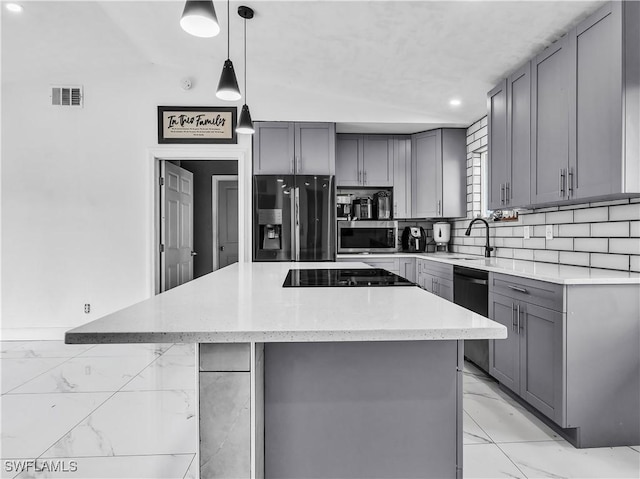 kitchen with sink, gray cabinetry, decorative light fixtures, a kitchen island, and black appliances