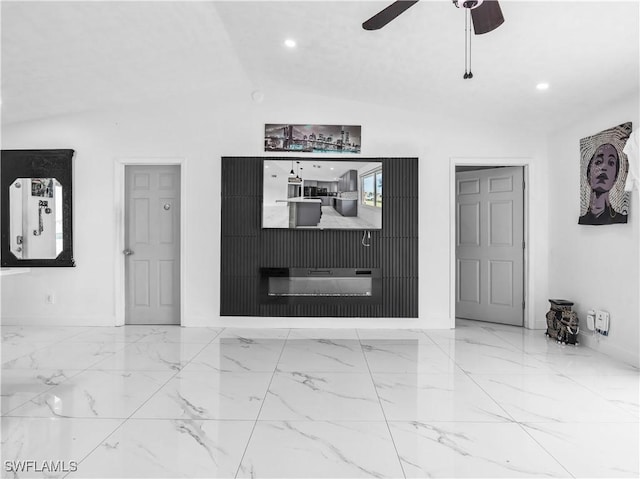 spare room featuring ceiling fan and vaulted ceiling