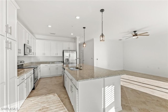 kitchen featuring white cabinetry, sink, light stone countertops, an island with sink, and appliances with stainless steel finishes