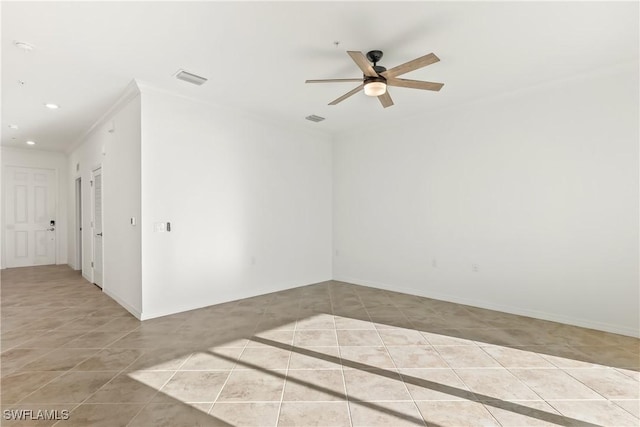 unfurnished room with ceiling fan, light tile patterned flooring, and crown molding