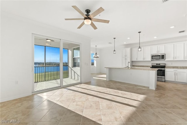 unfurnished living room with ceiling fan, crown molding, sink, a water view, and light tile patterned flooring