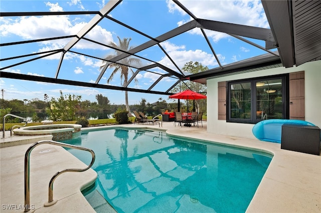 view of pool featuring a patio area, a pool with connected hot tub, and glass enclosure