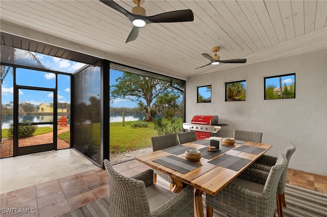 sunroom / solarium with a water view, wood ceiling, and ceiling fan