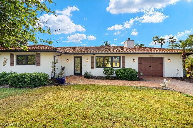 single story home with a front yard and a garage