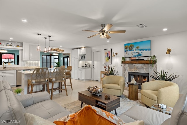 living area featuring recessed lighting, visible vents, a fireplace, and ceiling fan