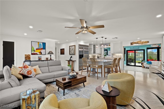 living area featuring a ceiling fan, visible vents, and recessed lighting