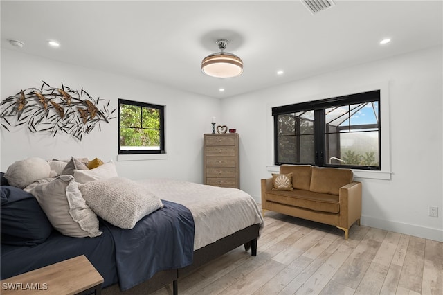 bedroom featuring light wood-style floors, baseboards, visible vents, and recessed lighting