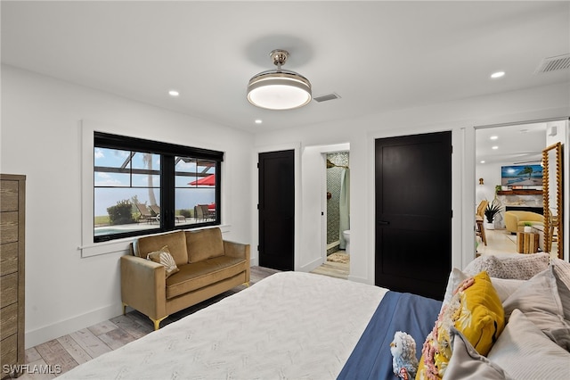 bedroom with wood finished floors, visible vents, and recessed lighting