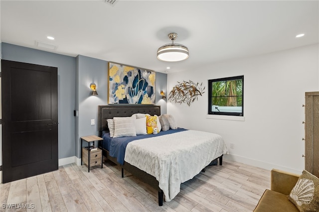 bedroom with recessed lighting, wood finished floors, and baseboards