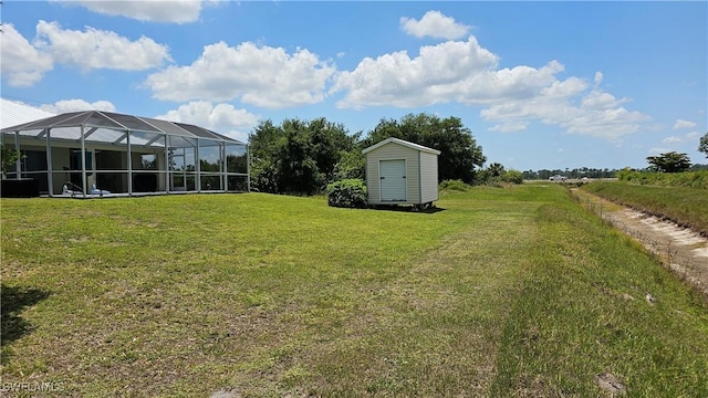 view of yard with a shed and glass enclosure