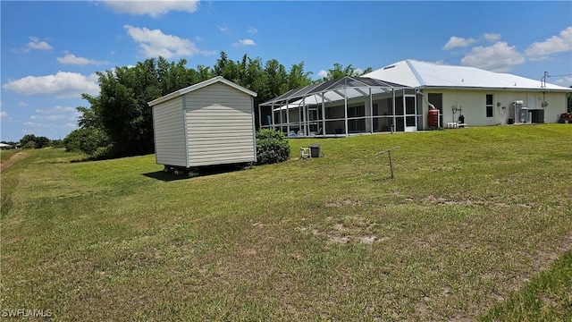 back of property featuring a lawn and glass enclosure