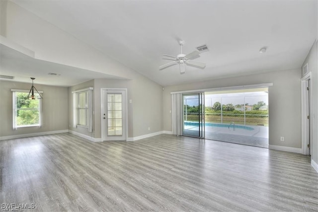 unfurnished room with light hardwood / wood-style flooring, ceiling fan, and lofted ceiling