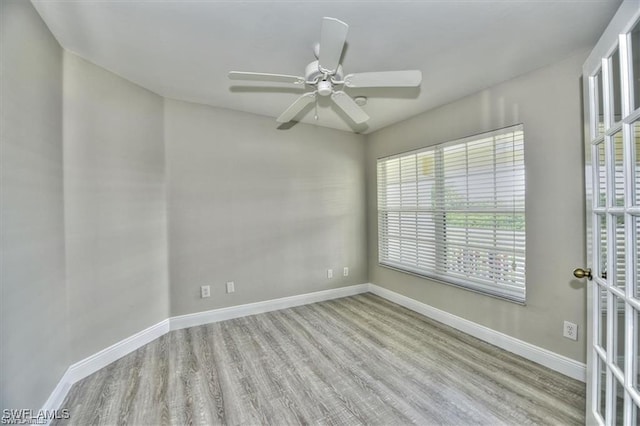 unfurnished room with ceiling fan and light wood-type flooring