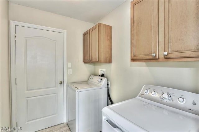 laundry area featuring cabinets and washing machine and clothes dryer