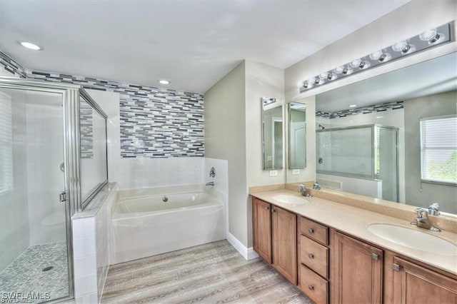 bathroom with hardwood / wood-style flooring, vanity, and independent shower and bath