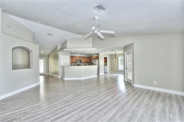 unfurnished living room with light hardwood / wood-style floors, ceiling fan, and lofted ceiling