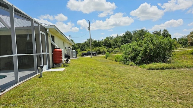 view of yard featuring glass enclosure