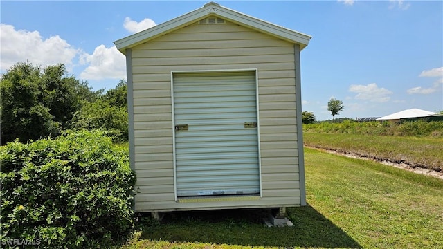 view of outbuilding with a yard