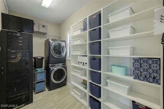 washroom featuring stacked washing maching and dryer