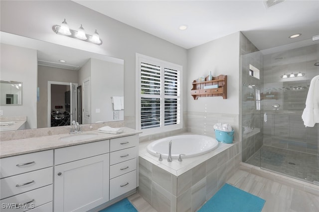 bathroom with vanity, tile patterned floors, and plus walk in shower