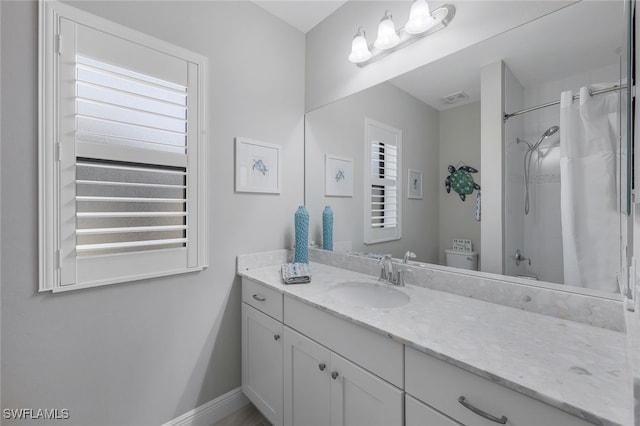 full bathroom featuring vanity, a healthy amount of sunlight, toilet, and shower / bath combo with shower curtain