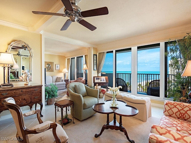 tiled living room featuring a water view, ceiling fan, and crown molding