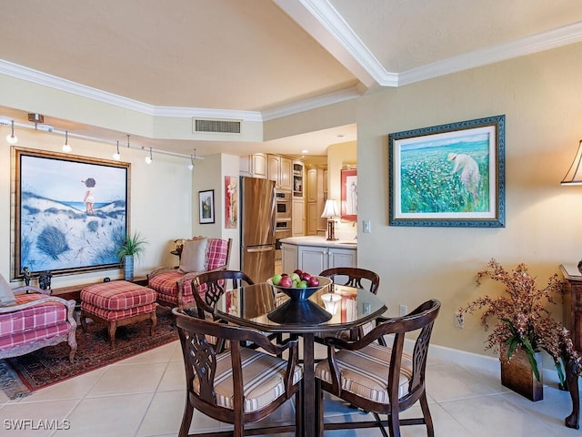 tiled dining area with track lighting and ornamental molding